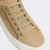 Suede sneakers, sand